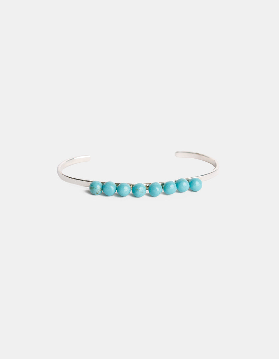 Brazalete de bronce con baño de rodio y piedra turquesa