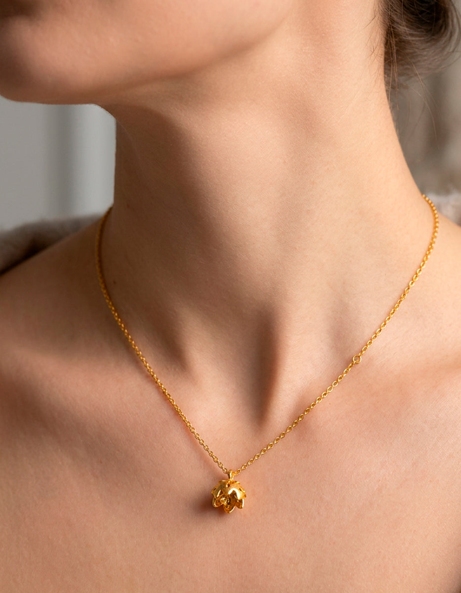 Cadena con dije de flor de loto en bronce con baño de oro 22 kt y espinolita brillante