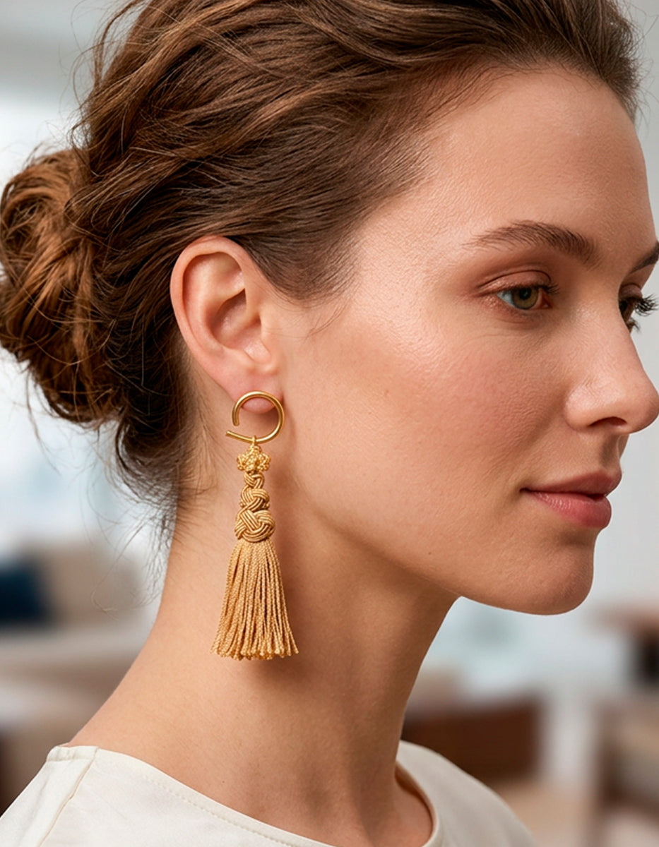 Aretes de bronce en baño de oro 22 kt con gancho semicircular, nudos artesanales y borla arena