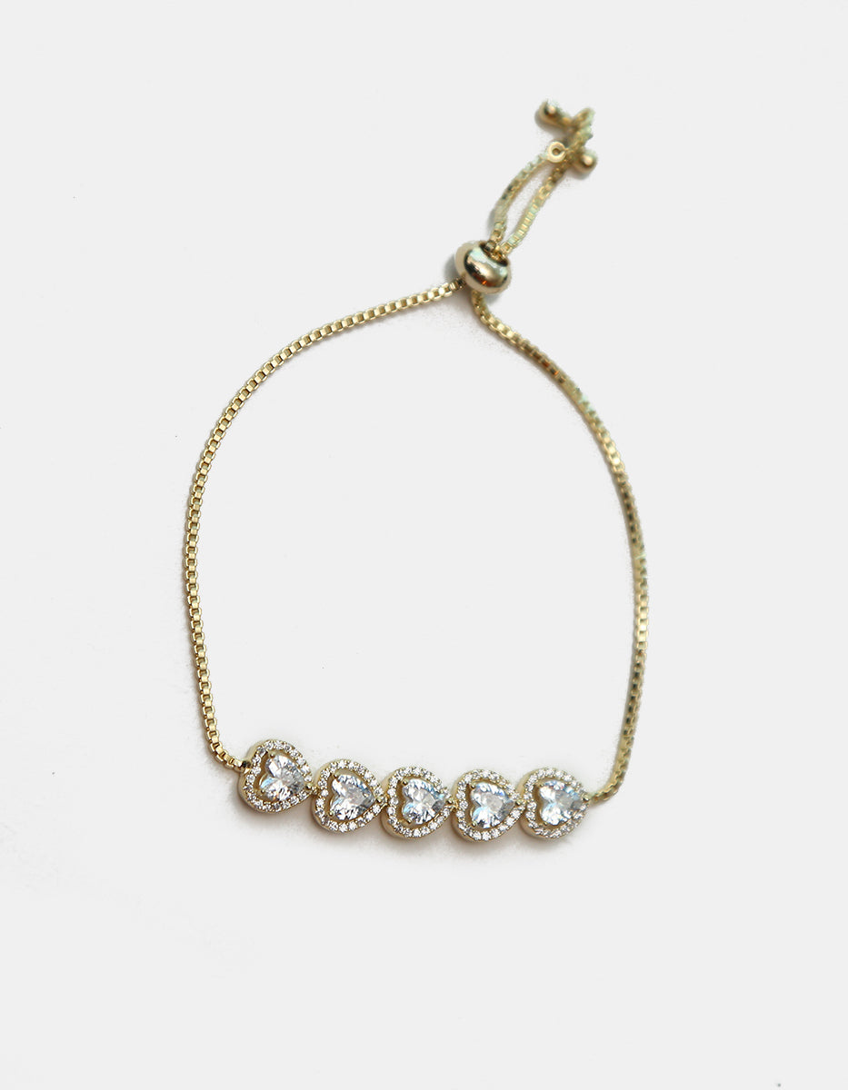 Pulsera ajustable en plata .925 con baño de oro 22 kt, cinco corazones y topacios blancos Amor Eterno