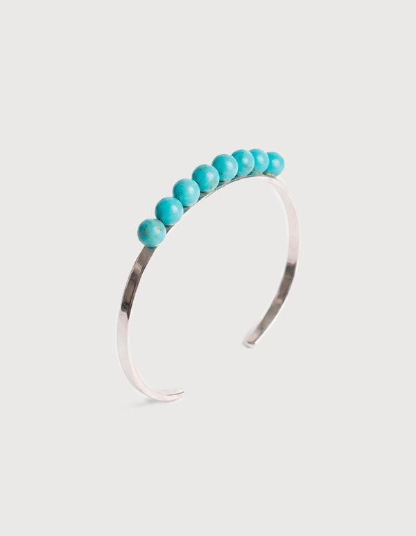 Brazalete de bronce con baño de rodio y piedra turquesa