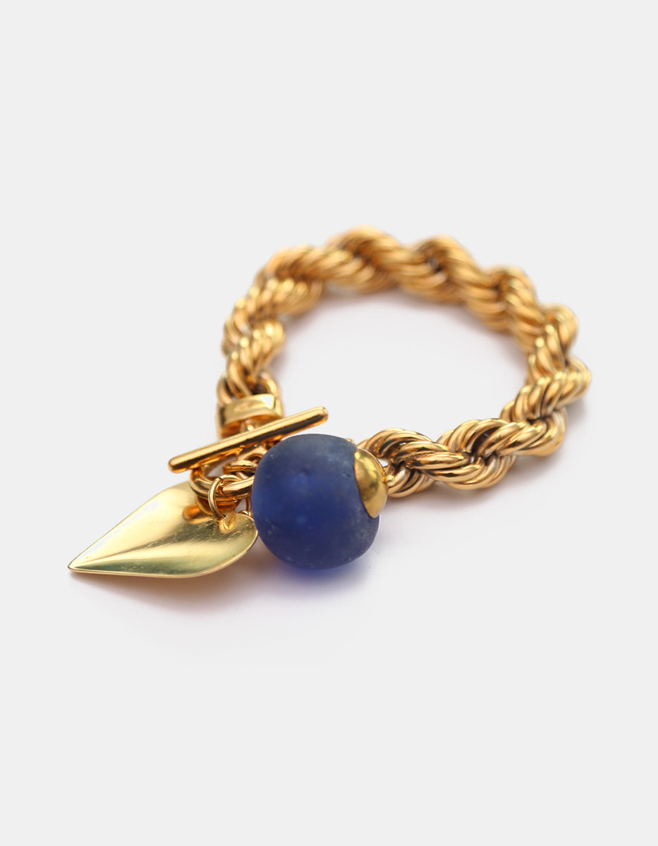 Pulsera de bronce en baño de oro 22 kt con hoja y cristal azul rey