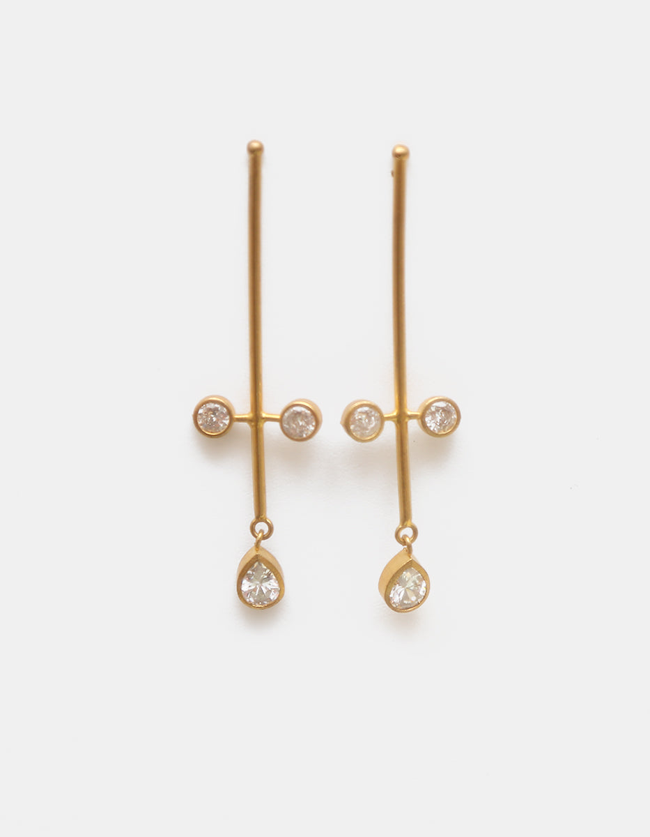 Aretes de oro laminado 22 kt con barra vertical y topacios blancos corte brillante y pera