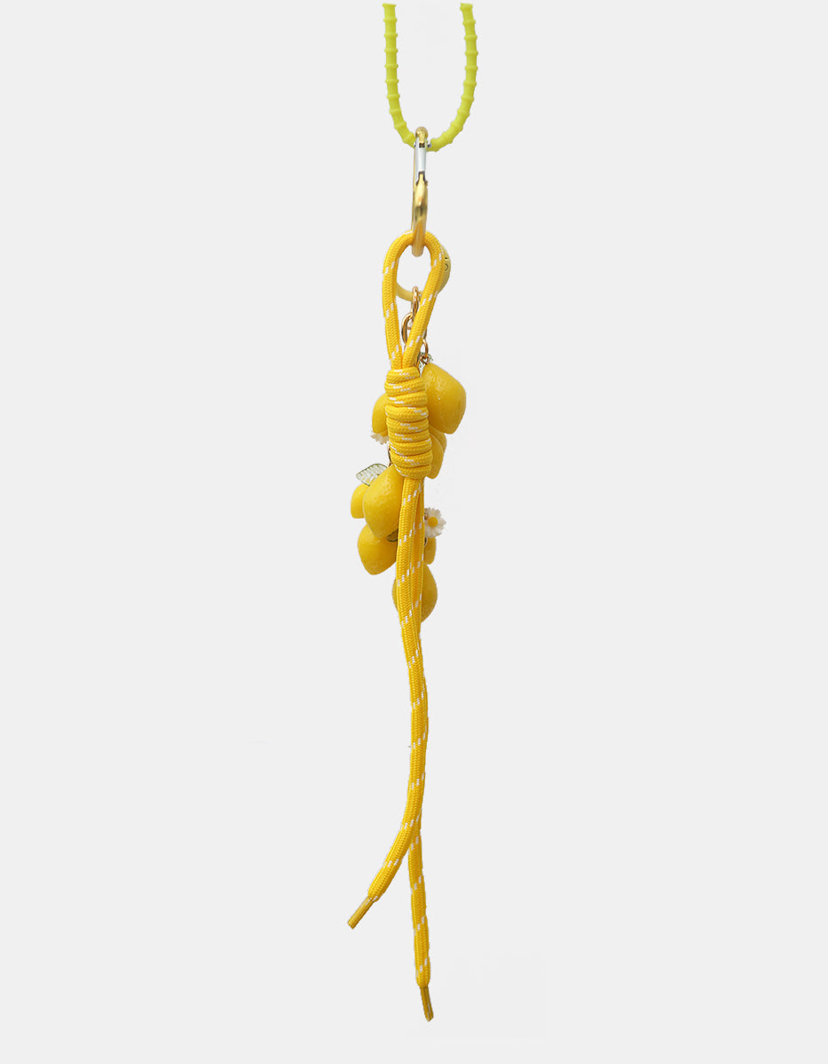 Charm para bolso en oro laminado y baquelita con dijes de limones y cordón náutico Ultramar