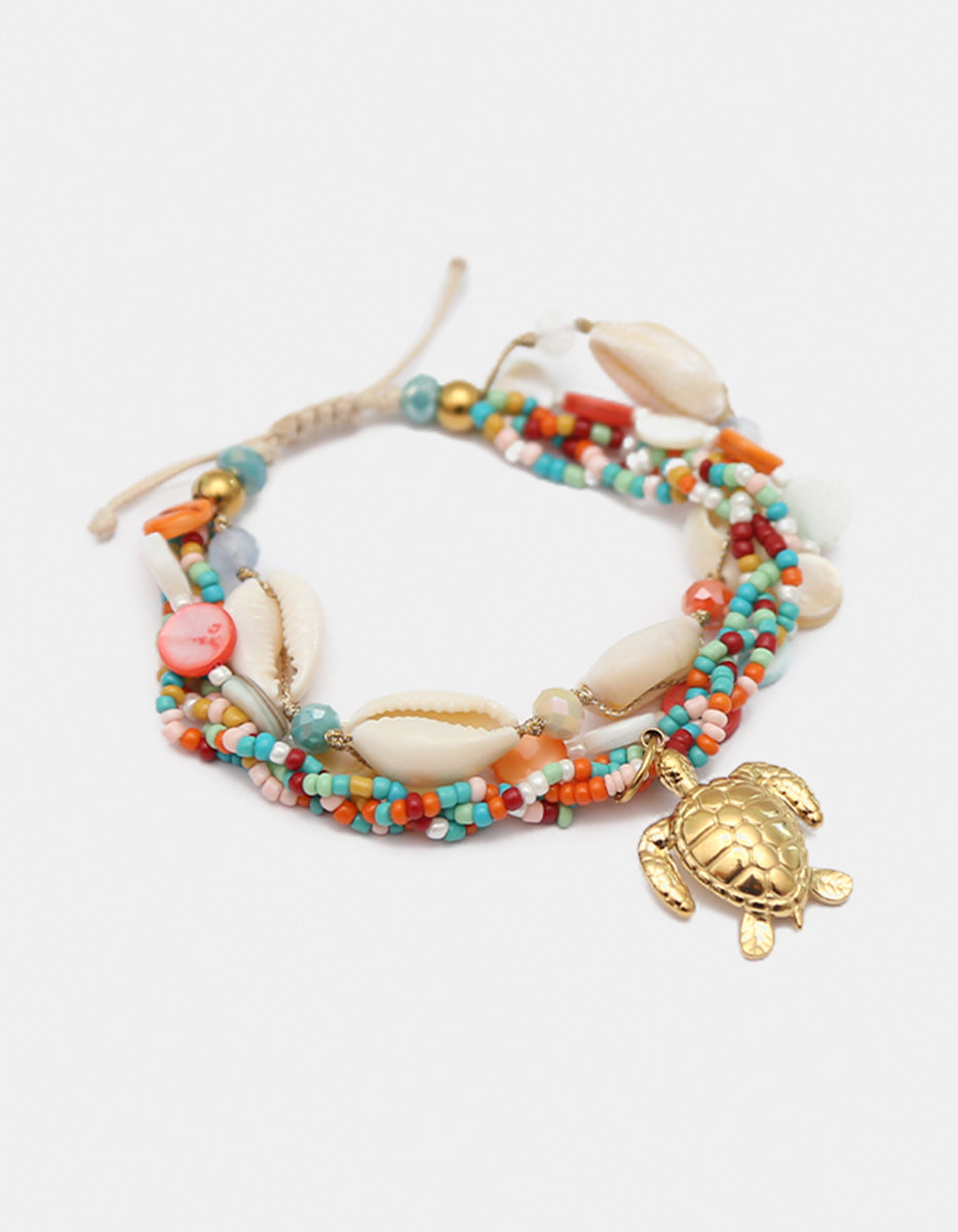 Pulsera de motivos marinos y charm de tortuga de bronce en baño de oro de 22kt Ultramar