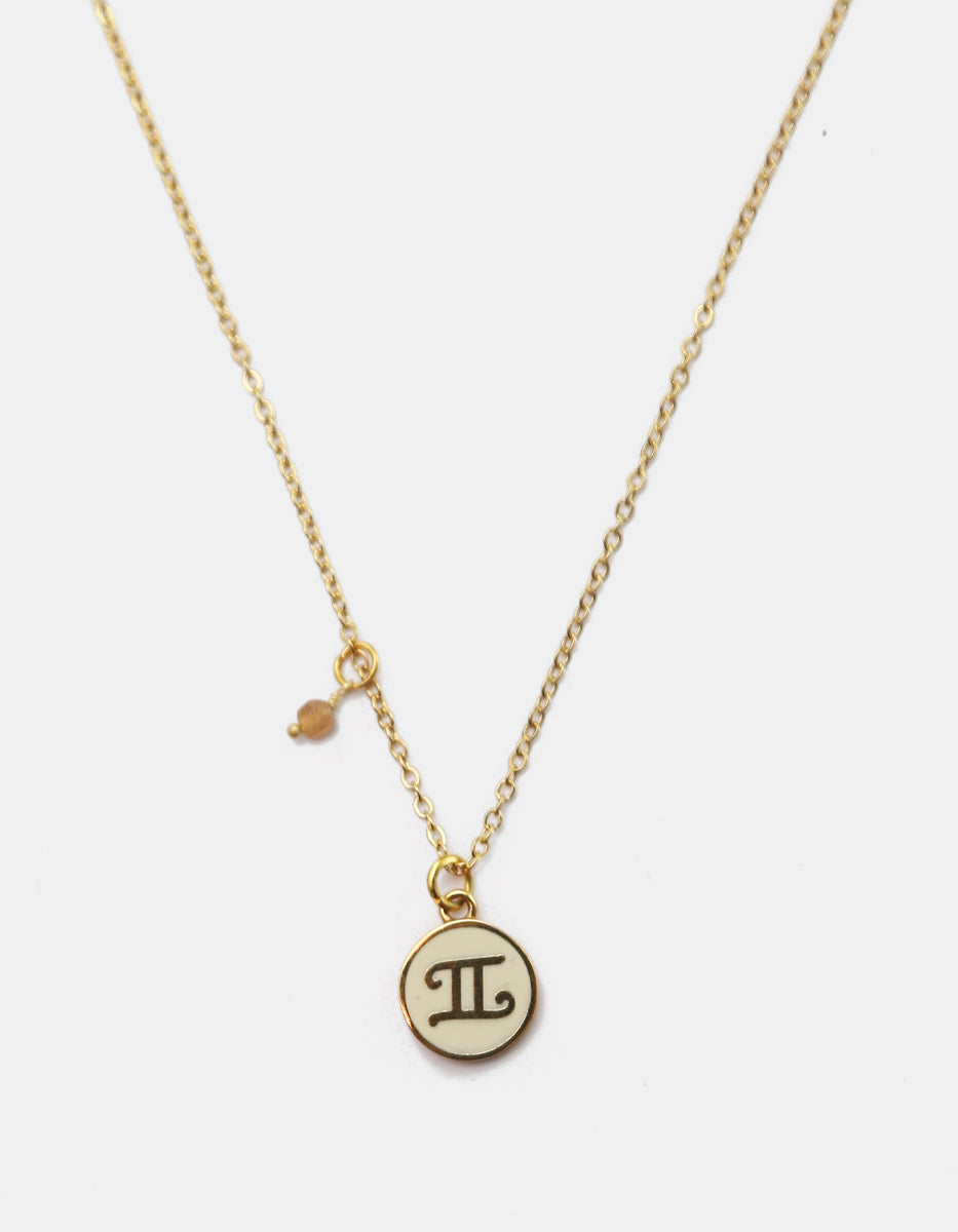 Collar Gold-Filled de 22kt con charm esmaltado de Géminis y cristal austriaco color durazno Zodiac