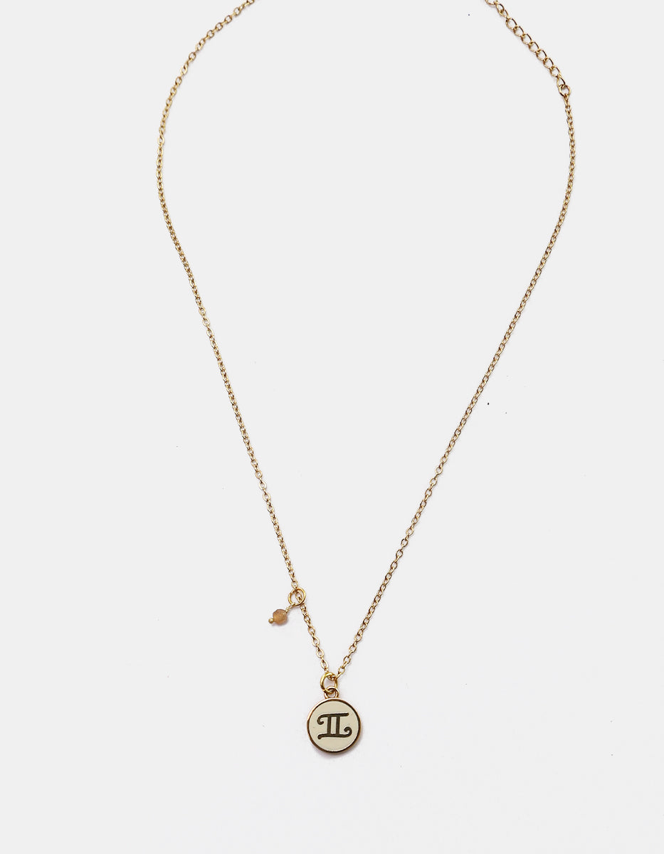 Collar Gold-Filled de 22kt con charm esmaltado de Géminis y cristal austriaco color durazno Zodiac