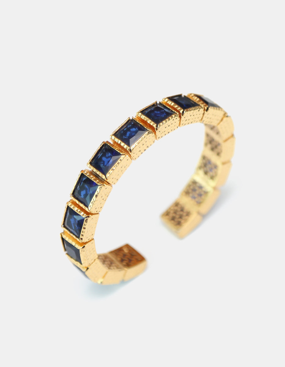Brazalete de bronce con baño de oro 22k con zafiro azul en diseño de cuadros Flashy Moments